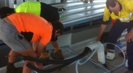 Johnny Cool Darwin team fitting off the Electrical wiring and cabling for roof mounted condensors